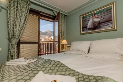 a bedroom with a large bed and a window at Къща за гости Карлък in Smolyan