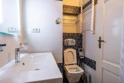 a small bathroom with a sink and a toilet at Къща за гости Карлък in Smolyan