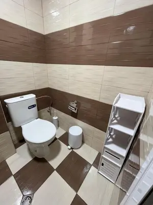 a small bathroom with a toilet and a sink at BoxRoom1 in Kyustendil
