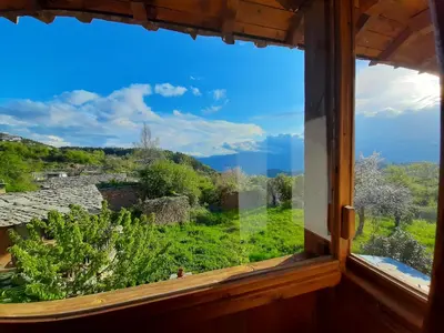 a window with a view of a green field at Spa&Relax Скендерова Къща in Leshten