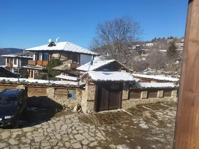 a house with snow on top of it at Spa&Relax Скендерова Къща in Leshten