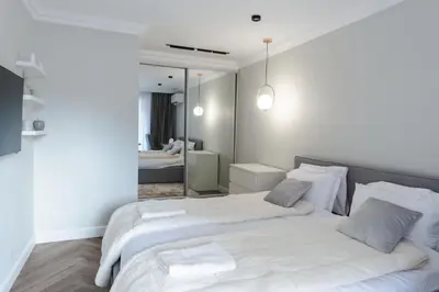 a bedroom with two beds and a mirror at Simaya, your home in the heart of Sandanski in Sandanski