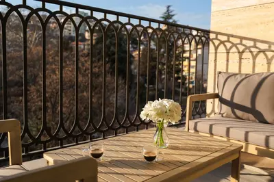 a vase of flowers on a table on a balcony at Simaya, your home in the heart of Sandanski in Sandanski