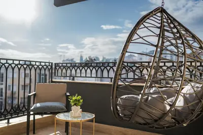 a room with a chair and a swing on a balcony at Simaya, your home in the heart of Sandanski in Sandanski