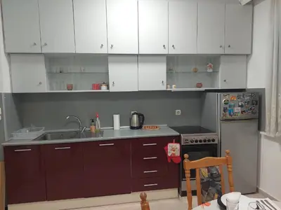 a kitchen with white cabinets and a sink at апартамент У дома in Plovdiv