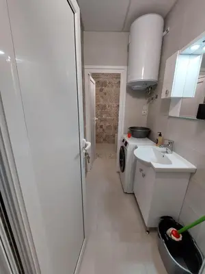 a small kitchen with a sink and a washing machine at апартамент У дома in Plovdiv