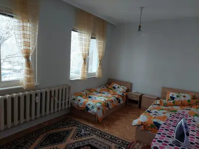 a bedroom with two beds and a crib at апартамент У дома in Plovdiv