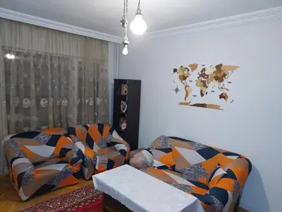 a living room with a couch and a table at апартамент У дома in Plovdiv