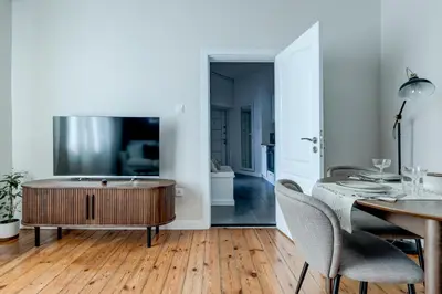a living room with a tub and a table at Cozy Bright Space in the Heart of Women's Market in Sofia