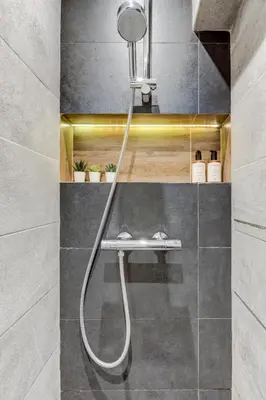 a shower with a hose in a bathroom at Cozy Bright Space in the Heart of Women's Market in Sofia