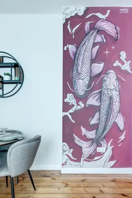 a painting of two koi fish on a red background door curtain at Cozy Bright Space in the Heart of Women's Market in Sofia