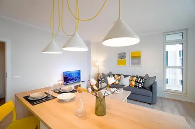 a living room with a table and a couch at Scandinavian Airy APT in Business Area & Airport in Sofia