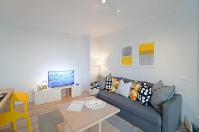 a living room with a couch and a table at Scandinavian Airy APT in Business Area & Airport in Sofia
