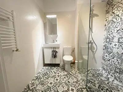 a bathroom with a toilet and a glass shower at Scandinavian Airy APT in Business Area & Airport in Sofia