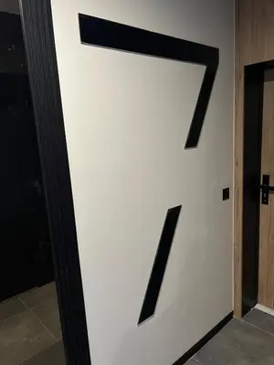 a white wall with a black letter z on it at Comfort Airport Metro Suite in Sofia