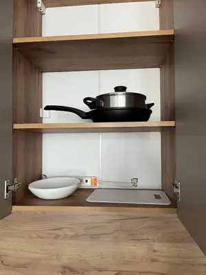 a kitchen with a sink and a pot on a shelf at Comfort Airport Metro Suite in Sofia