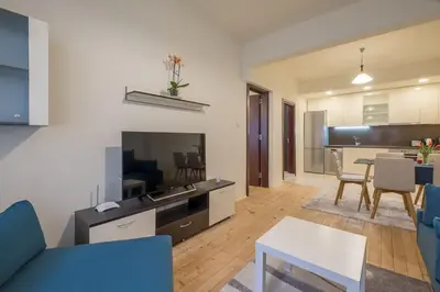 a living room with a kitchen and a dining room at Stylish TOP center Flat 100m to Vitosha blvd in Sofia