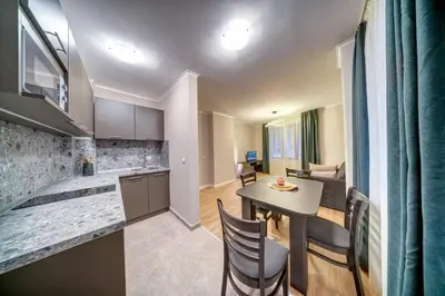 a kitchen and dining room with a table and chairs at Dream View Family Retreat in Pamporovo