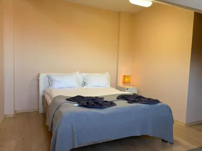a bedroom with a bed with a blue blanket on it at Bansko Spomar in Bansko