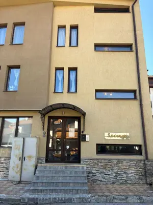 a building with stairs in front of a building at Bansko Spomar in Bansko