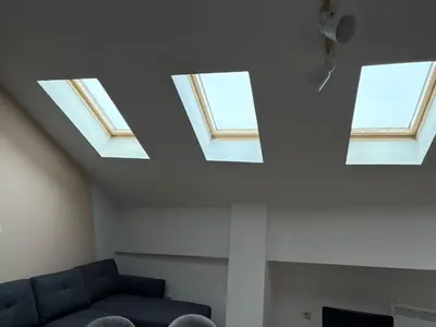 a living room with three skylights in the ceiling at Bansko Spomar in Bansko