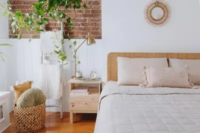 a bedroom with a bed and a table with a plant at Luxury Apartment Bansko in Bansko