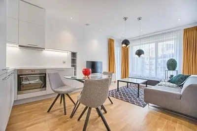 a kitchen and living room with a table and chairs at Luxury Apartment Bansko in Bansko