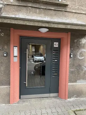 a door to a building with a reflection of a car at Art city studio in Sofia center in Sofia