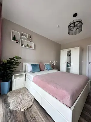 a bedroom with a large bed with a pink blanket at Elegance28 - Stylish Mountain Retreat in Bansko by Flat Mаnager in Bansko