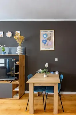 a dining room with a wooden table and blue chairs at Modern 1 Bedroom by the Gondola in Bansko