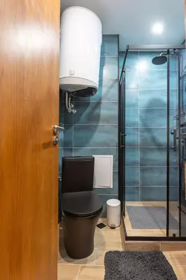 a bathroom with a toilet and a glass shower at Modern 1 Bedroom by the Gondola in Bansko