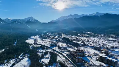 an aerial view of a city with snow covered mountains at Modern 1 Bedroom by the Gondola in Bansko