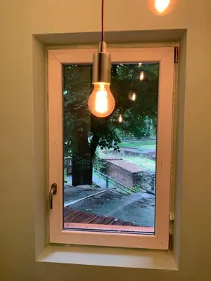 a light hanging over a window with a view at Cozy townhouse in the heart of Sofia in Sofia