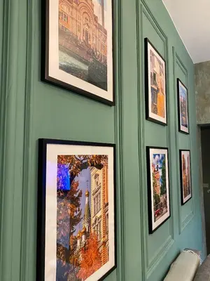 a green wall with pictures on it at Cozy townhouse in the heart of Sofia in Sofia