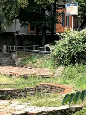 a building with stairs and a sign in front of it at Cozy townhouse in the heart of Sofia in Sofia
