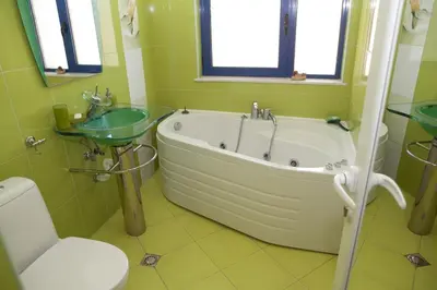 a bathroom with a tub and a sink and a toilet at Spa Villa Crystal in Hisarya