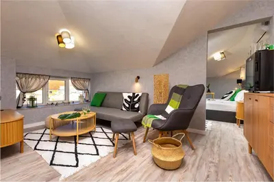 a living room with a couch and a table at Kapana Art Sky Studios Parking Included in Plovdiv