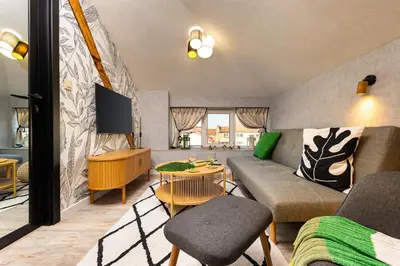 a living room with a couch and a tv at Kapana Art Sky Studios Parking Included in Plovdiv