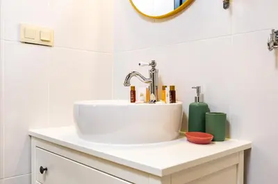 a bathroom with a white sink and a mirror at Kapana Art Sky Studios Parking Included in Plovdiv