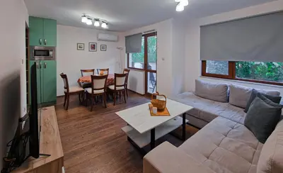 a living room with a couch and a table at Next to Kapana - Art Apartment in Plovdiv