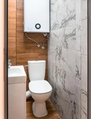 a bathroom with a toilet and a sink at Next to Kapana - Art Apartment in Plovdiv