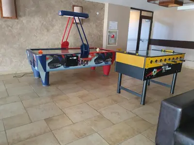 a ping pong table in a living room with a ping pong tableablish at AZAX Apartments in Terra Complex in Bansko