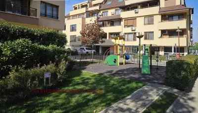 a playground in a yard in front of a building at Cite Jardin in Sofia