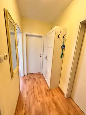 an empty hallway with a door and a mirror at Cite Jardin in Sofia