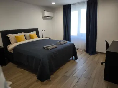 a bedroom with a bed with two towels on it at Victoria Elegance Apartment in Sofia