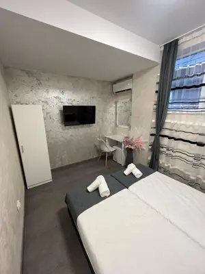 a bedroom with a bed with two towels on it at BoxRoom2 in Kyustendil