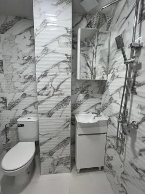 a bathroom with a toilet and a sink and a mirror at BoxRoom2 in Kyustendil