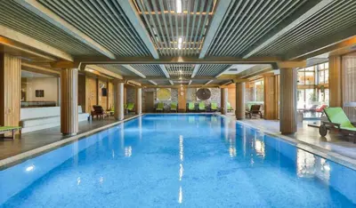 a large swimming pool in a large building at Pirin Golf Resort & SPA Two-Bedroom Apartment in Razlog