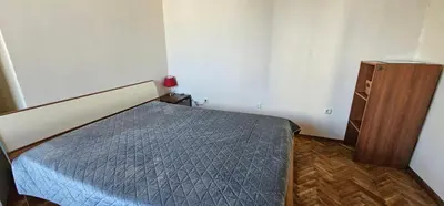 a small bedroom with a bed and a dresser at Home away from home in Sofia
