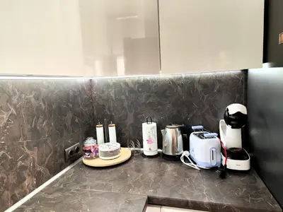 a kitchen counter with appliances on a counter top at Prima apartment in Sofia